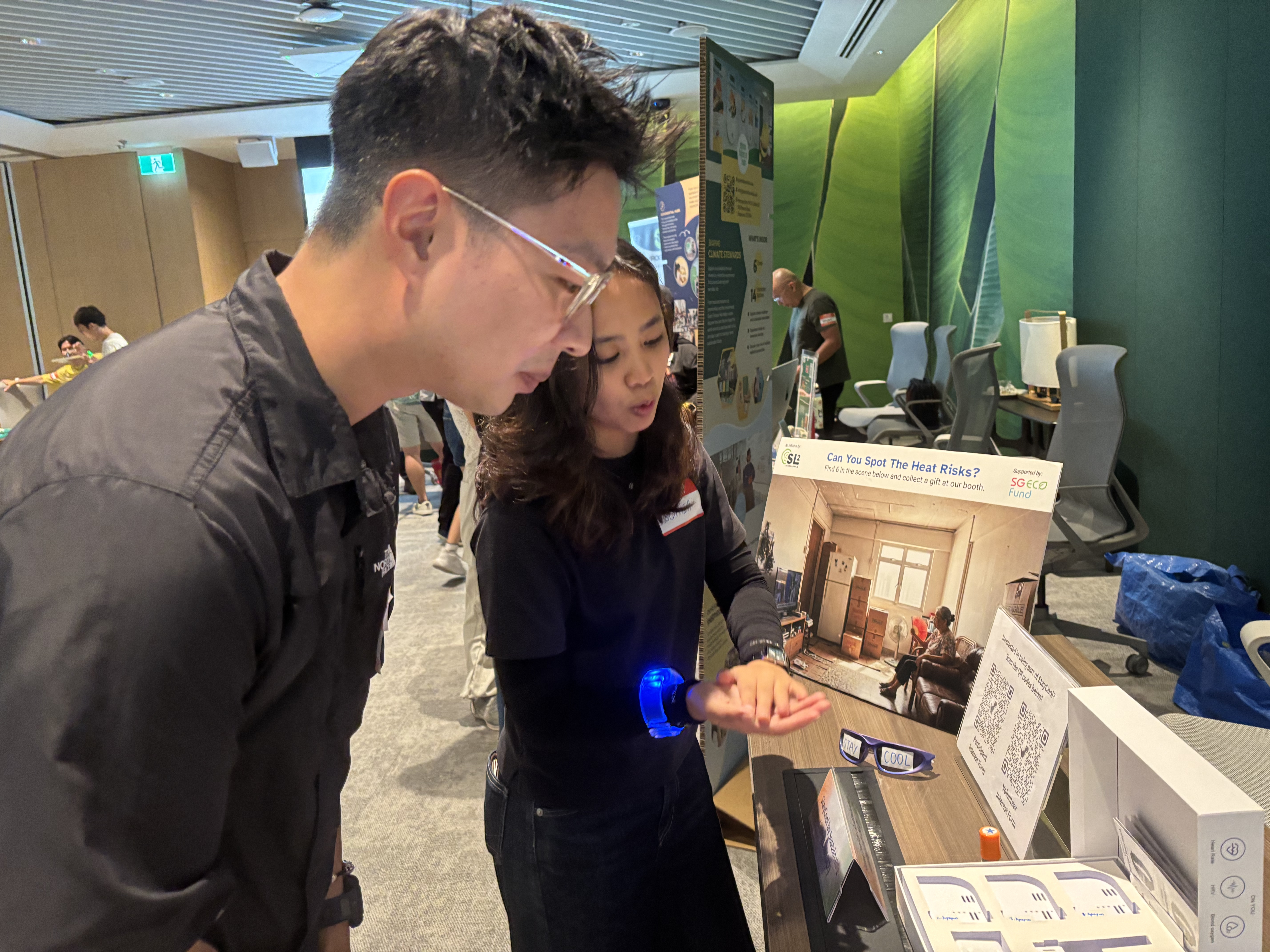 A StayCool volunteer sharing her experience with a participant at a youth sustainability event, sparking conversations about heat, community action and ways to get involved.